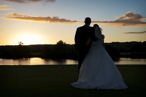 Bride and Groom Watching Sunset over the River Thames at Bisham Abbey